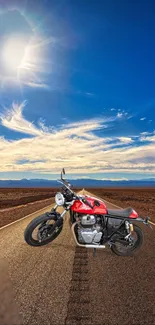 Motorcycle on desert road under vibrant blue sky and sun.