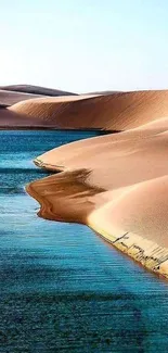 Desert oasis with sand dunes and blue water mobile wallpaper.