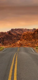 Scenic desert road at sunset with orange skies and rugged mountains.