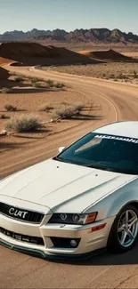 White sports car on desert winding road.