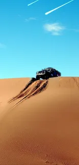 SUV ascending desert sand dunes under blue sky in scenic wallpaper.