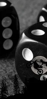 Dice and biker silhouette on a black and white wallpaper.