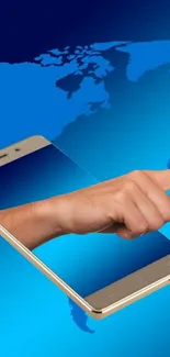 Hand emerging from smartphone over world map on a blue background.