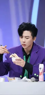 Person enjoying a meal in a vibrant purple-themed setting.