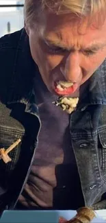 Man enjoying a meal outdoors with chopsticks.