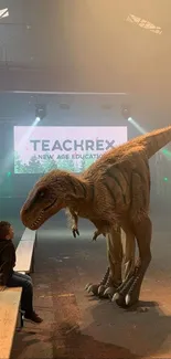 A dinosaur model in a dimly lit venue with spectators on benches.