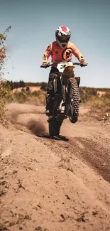 Dirt bike rider performing a stunt on a dusty desert track.