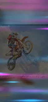 Motocross rider in mid-air against a colorful background.