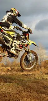 Motocross rider in action on a dirt track.