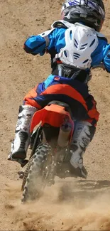 Dirt bike racing through dusty terrain in motocross action scene.