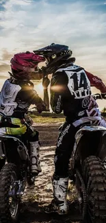 Two dirt bikers racing during sunset on rugged terrain.