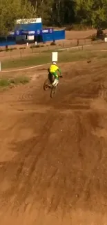 Biker performing jump on a dirt track.