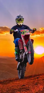 Motocross rider jumps during sunset on a mountainous landscape.