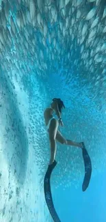 Diver surrounded by fish underwater in clear blue ocean.