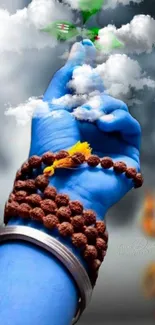 Blue hand reaching through clouds with beads and green leaves.