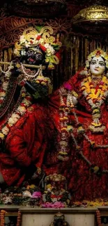 Colorful depiction of religious deities adorned in red floral garments.