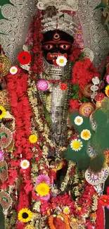 Hindu deity adorned with vibrant flowers and traditional decorations.