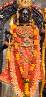 Statue of a Hindu deity adorned with flowers and traditional attire.