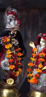 Divine figurines with floral decor in a rustic setting.