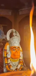 Mobile wallpaper of a deity with a glowing flame, capturing spirituality.