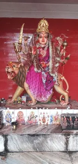 Goddess Durga statue with red background.