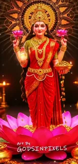 A goddess in red saree holding lotus flowers.