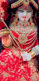 Vibrantly dressed goddess statue with ornate jewelry.