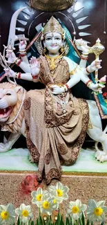 Divine goddess seated on a lion with ornate background.