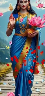 Goddess in blue traditional attire surrounded by flowers.