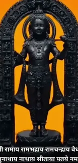 Black statue of Lord Rama with orange background.