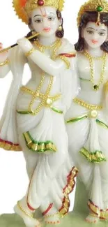 Radha and Krishna statue in traditional attire.