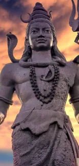 Majestic Shiva statue with a sunset sky backdrop.