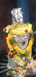 Shiva Lingam adorned with colorful flowers.