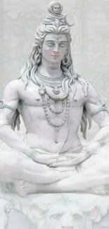 Serene meditation statue of Lord Shiva against a misty background.