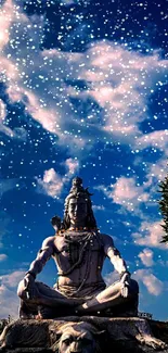 Lord Shiva statue meditating beneath cloudy blue sky.