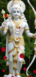 Serene white statue with red flowers in a lush green nature setting.