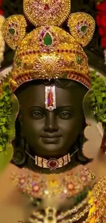 Ornate Hindu deity statue with gold adornments and vibrant flowers.