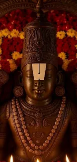 Statue with floral garland and intricate ornaments.