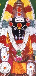 Varahi Devi adorned with flowers and jewelry, set against a green background.