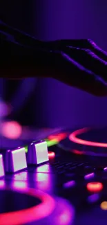 A DJ mixing music with neon lights creating an energetic vibe.