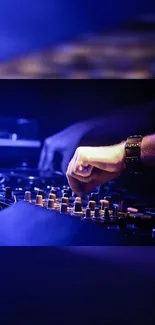 Close-up of a DJ mixer with electric blue lighting.