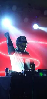 DJ on stage with vibrant neon red lights and energetic ambiance.