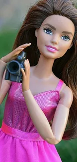 Doll with camera in a pink dress mobile wallpaper.