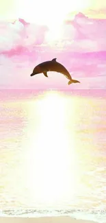 Dolphin leaping against a pink sunset over the ocean.