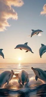 Dolphins leaping over the ocean at sunset with a stunning sky backdrop.