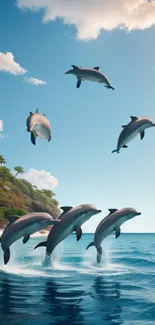 Dolphins leaping over ocean waves near tropical coast under a blue sky.