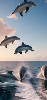 Dolphins leaping across the ocean with a sunset backdrop.