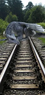 A dragon rests on railroad tracks surrounded by lush greenery.