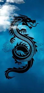 Black dragon silhouette on blue cloudy background wallpaper.