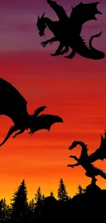 Dragon silhouettes flying in a vibrant orange sunset sky.